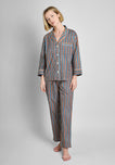 A woman wearing the woodblock print pajama set on a grey background.