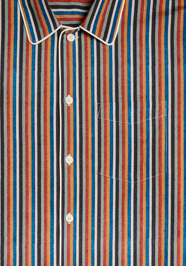 a detail  image of the collar of of the woodblock print pajama set, which multicolored stripes including red,orange, blue, white, brown, and seafoam green.